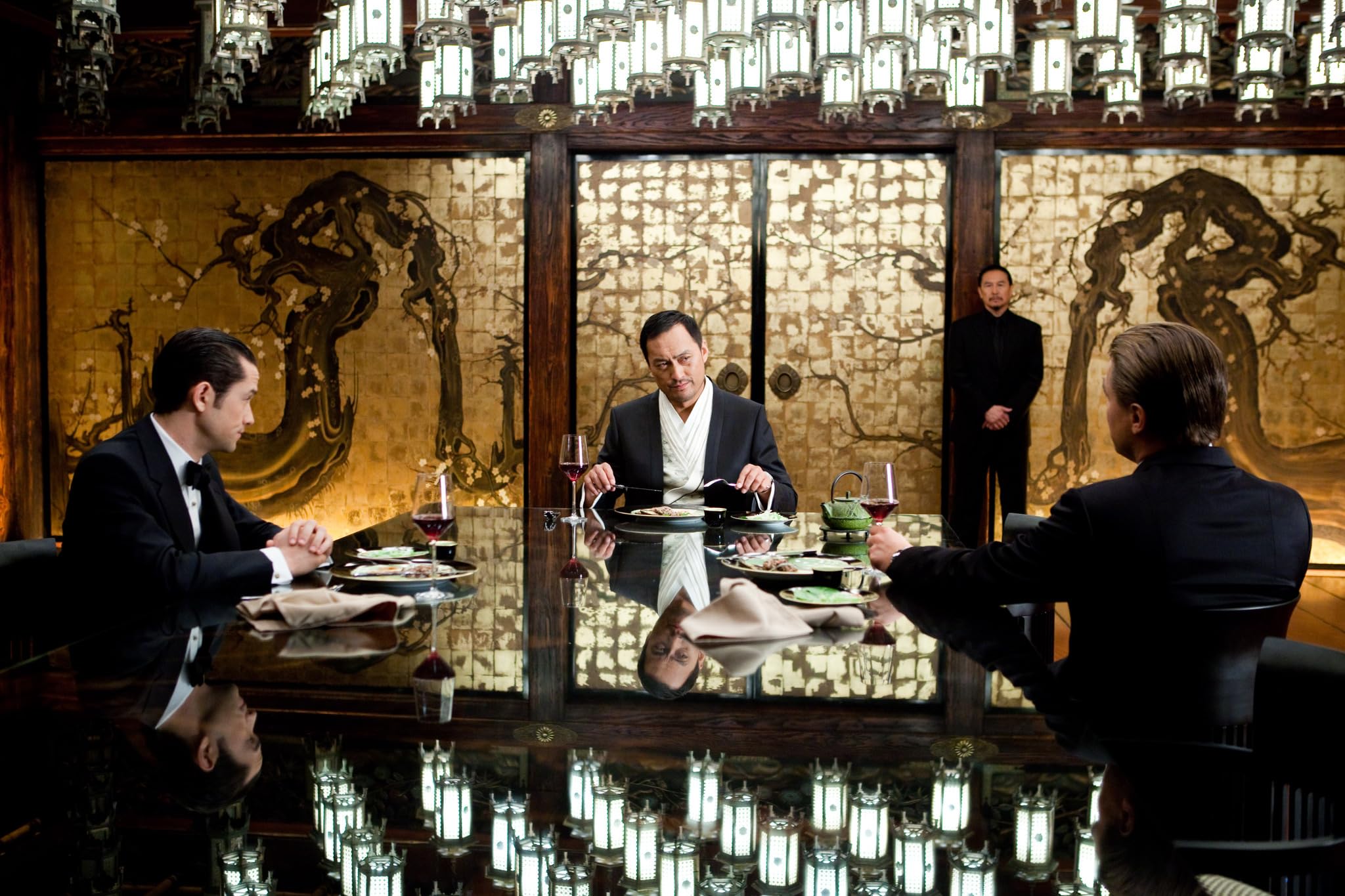 Arthur coordinating with the team during a critical dream layer operation